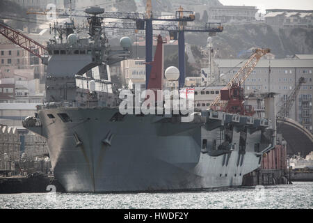 The British Royal Navy carrier HMS Ocean berthed at the British Naval Base in Gibraltar on the 18th March 2017 as it prepared to make its way to the U Stock Photo