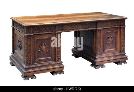 Antique mahogany writing desk with ornate carving on the panels and raised feet for a bureau or office isolated on white Stock Photo