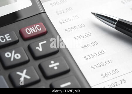 Ballpoint pen, printed document and a large calculator on the table Stock Photo