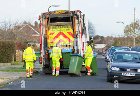 Several dustmen with a dustcart collecting rubbish on bin day in the South of England, UK. Stock Photo