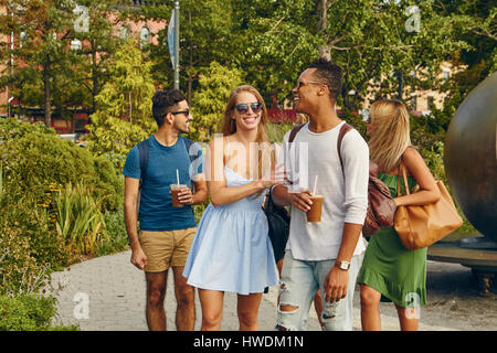 Five adult friends strolling together in park Stock Photo
