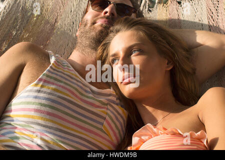 Couple relaxing in hammock Stock Photo