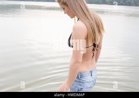 Woman contemplating by river Stock Photo