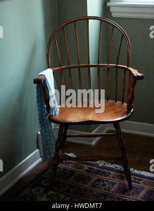 Empty chair in corner of room Stock Photo