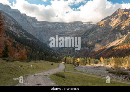A stream and road in the Cirque de Gavarnie in the Pyrenees in France in autumn Stock Photo