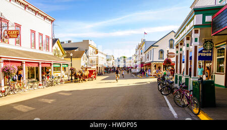 Mackinac Island, Michigan, August 8, 2016: Vacationers take on Market Street on Mackinac Island that is lined with shops and restaurants. No motorized Stock Photo