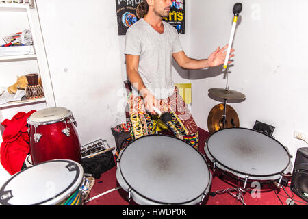 young man playing the drums in a room Stock Photo