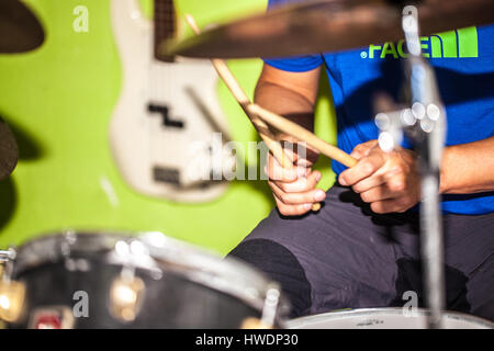 young man playing the drums in a room Stock Photo