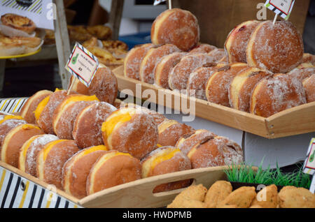 Portuguese donuts displayed on a market stall. Stock Photo