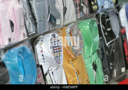 Smart, colourful shirts on display in a shop window. Stock Photo