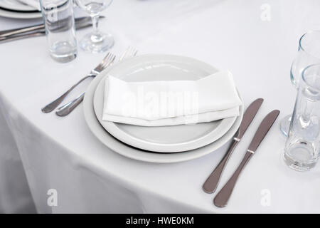 Empty plate on the table, cutlery set. Table appointments Stock Photo