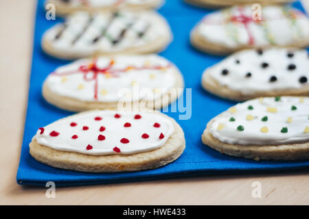 Colorful easter home gingerbread cookies in the shape of an egg on a blue background Stock Photo