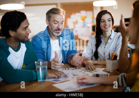 Creative business team discussing a plan in office Stock Photo