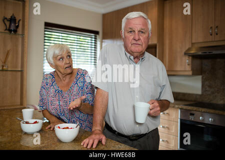 Senior couple arguing in kitchen at home Stock Photo