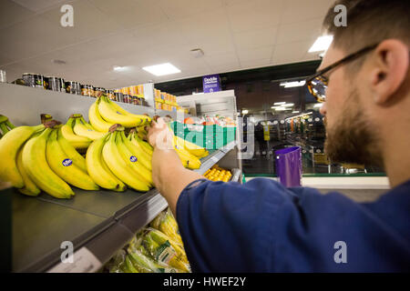 A man buys bananas in a Morrisons supermarket Stock Photo