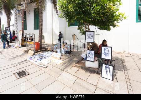 JAKARTA, INDONESIA - OCTOBER 9, 2016: Street artists wait for customers on the pedestrian street of Jakarta old town (Kota Tua) lined with Dutch colon Stock Photo