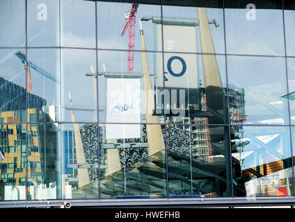 Abstract reflections of Peninsula Square in the glass of North Greenwich station Stock Photo