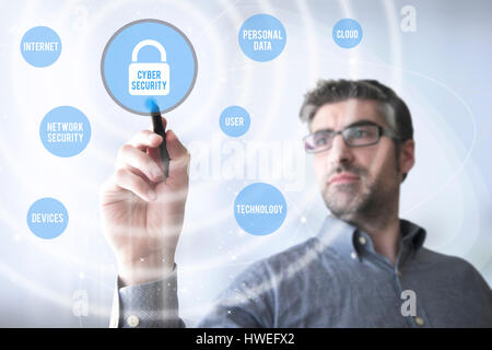 man touching a virtual screen with cyber security app Stock Photo