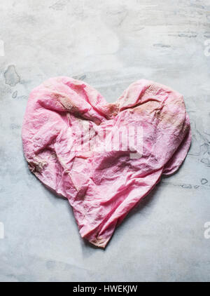Studio shot, overhead view of pink heart shaped cloth Stock Photo