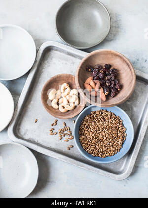 Studio shot, overhead view of cashew nuts, almonds, seeds and dried fruit in bowls Stock Photo