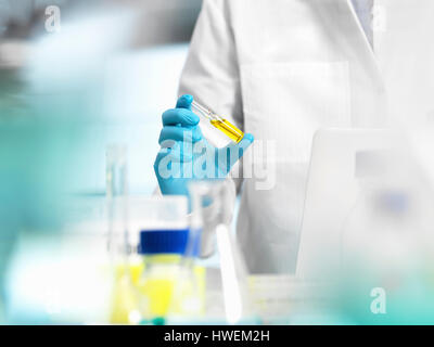 Pharmaceutical Research, doctor preparing a medicine phial for a medical trial Stock Photo