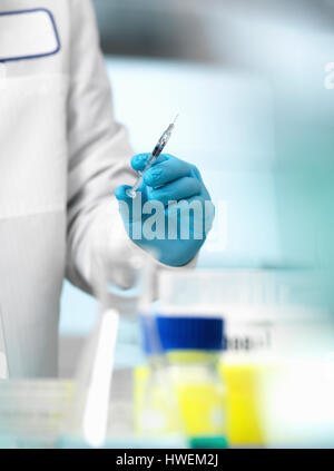 Pharmaceutical Research, doctor preparing a syringe for a medical trial Stock Photo