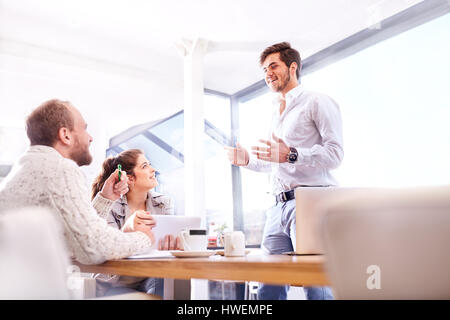 Young businessman making presentation to business team in office Stock Photo