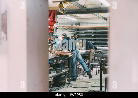 Metalwork team working in forge workshop Stock Photo
