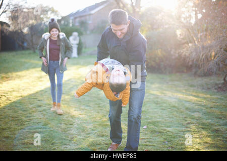 Happy family playing in garden Stock Photo