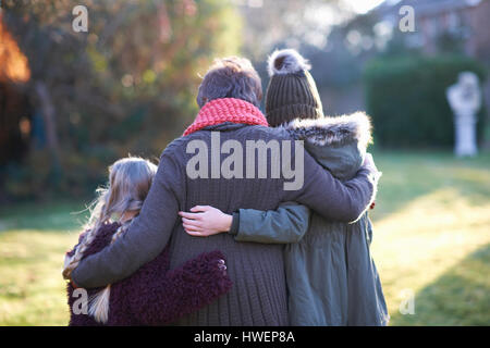 Grandmother and granddaughters hugging in garden Stock Photo