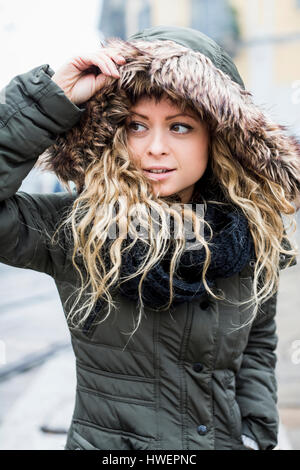 Portrait of woman wearing fur trimmed hooded coat Stock Photo