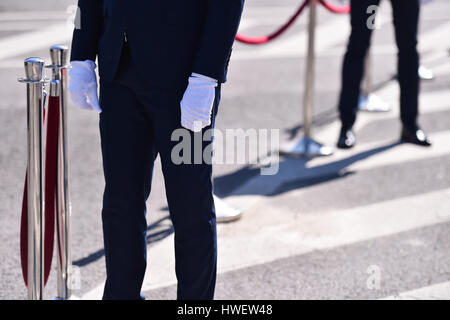 Detail with man in suit and white gloves at a reception Stock Photo