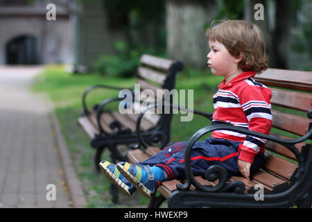 boy kid bench parl alone Stock Photo