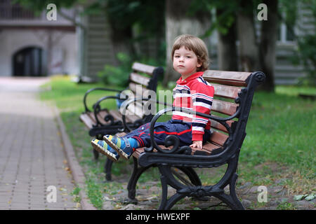 boy kid bench parl alone Stock Photo