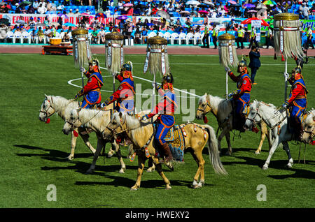 Entry on horseback of the  Mongolian Armed Forces Honorary Guard in traditional uniform into the National Sports Stadium, opening of the Naadam Festiv Stock Photo