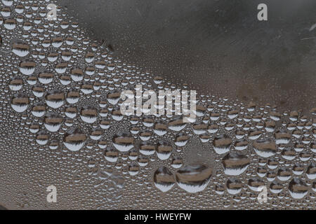 Water droplets and frost on window on a cold day. Stock Photo