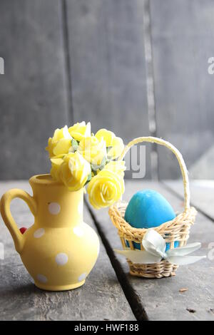 Easter egg in a basket on a vintage background And spring flowers Stock Photo