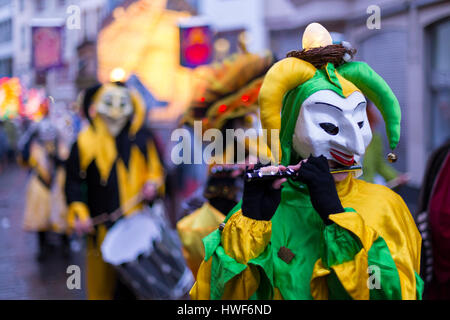Basel carnival. Basel, Switzerland - March 6, 2017. Close-up of a single carnival participant wearing a green and yellow costume and a clown mask. Stock Photo