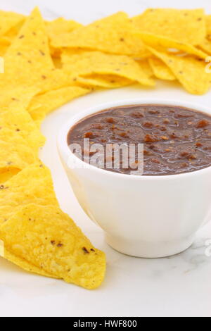 Artisan mexican chipotle sauce on vintage carrara marble table, with a delicious smoky flavor perfect for all your Mexican, tex-mex recipes and sides. Stock Photo