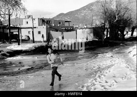 Taos New Mexico pueblo adobe homes native American Indian children playing. 1970s USA HOMER SYKES Stock Photo