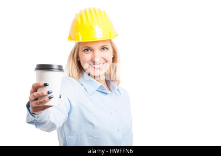Selective focus woman engineer wearing helmet showing coffee to go cup and smiling isolated on white background with copy text space Stock Photo