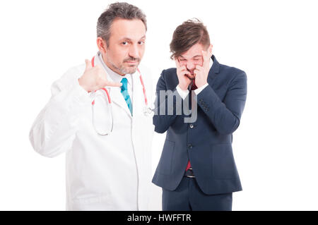Doctor doing call gesture and businessman suffering from migraine as health problem concept on white background Stock Photo