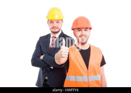 Young builder showing you the thumbs up or ok sign and smiling isolated on white background Stock Photo
