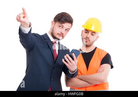 Attractive manager and engineer holding cellphone and pointing up isolated on white background Stock Photo