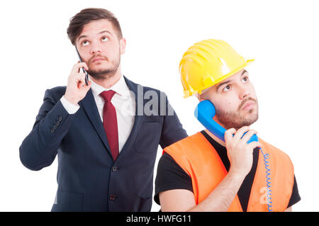 Sccessful businessman and engineer having a conversation on cellphone on white studio background Stock Photo