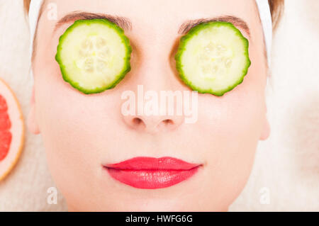 Spa relaxation concept with woman with clean skin in close up view with slices of cucumber on eyes Stock Photo