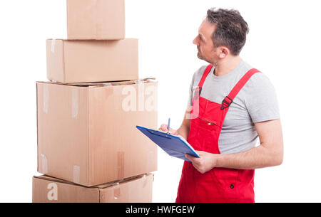 Mover guy counting or writing on clipboard with cardboard boxes around isolated on white background Stock Photo