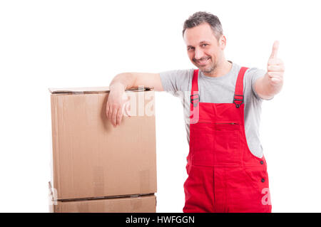 Mover man showing thumb up and smiling standing near cardboard boxes isolated on white background Stock Photo