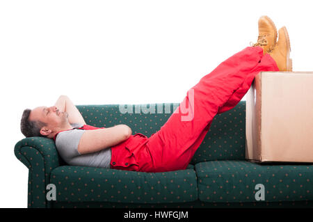 Mover man resting laid down on couch with feet up isolated on white background Stock Photo