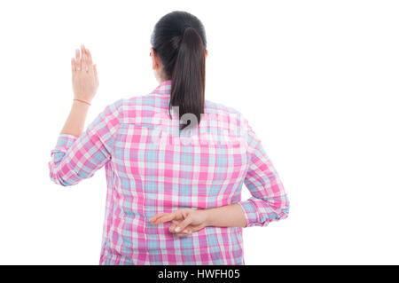 Back view of woman with crossed fingers as false statement concept on white background